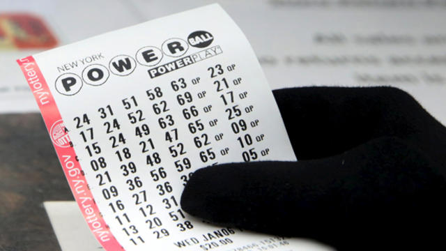 A woman holds a purchased Powerball lottery ticket in the Manhattan borough of New York Jan. 5, 2016. 