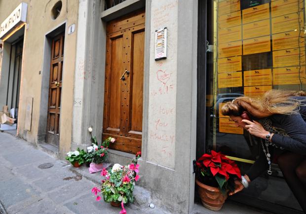 Flowers are laid outside the apartment of 35-year-old American Ashley Olsen in Florence 