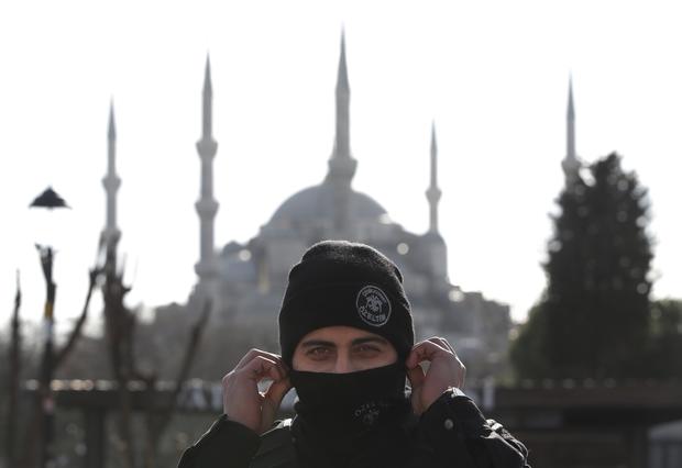 Backdropped by the Sultan Ahmed Mosque, better known as the Blue Mosque in the historic Sultanahmet district of Istanbul, a police officer secures the area after an explosion Jan. 12, 2016. The explosion killed several people and wounded 15 others. 