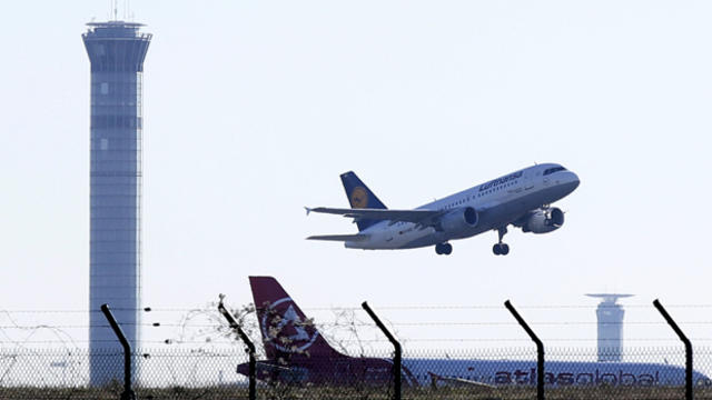 A Lufthansa airplane takes off past a control tower at the Charles de Gaulle Airport in Roissy, France, Jan. 25, 2016. 