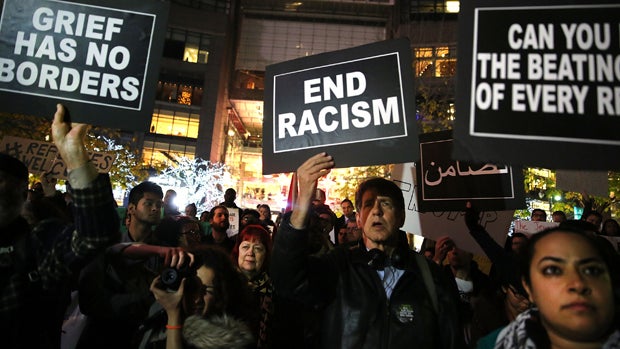 People listen to speakers at a demonstration against racism and conservative presidential candidate Donald Trump's remarks concerning Muslims on Dec. 10, 2015, in New York City. 