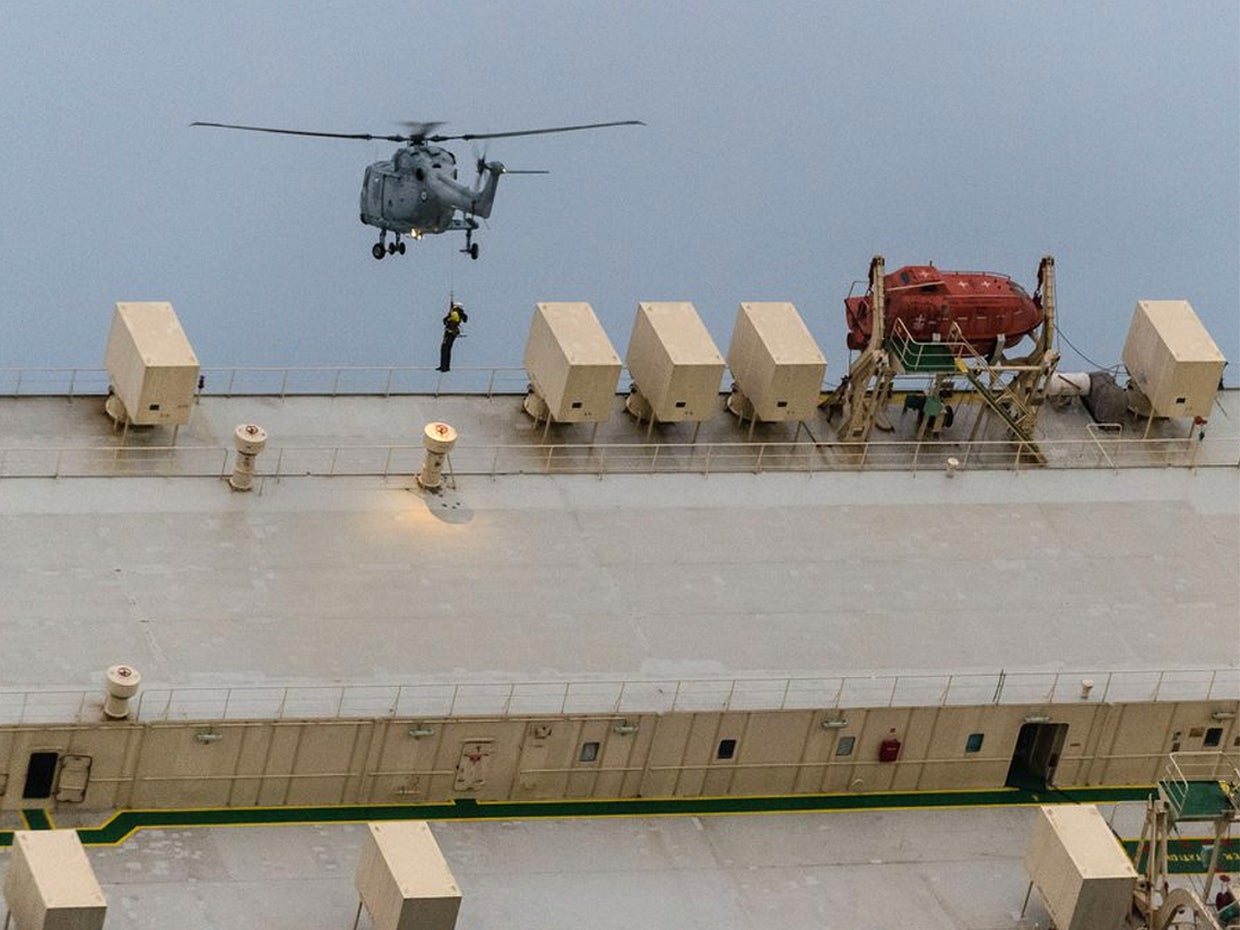 In this Jan. 31, 2016 image released by the French Maritime Authority, a helicopter lowers an SMIT Salvage expert onto the Modern Express 