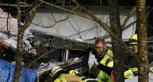 Members of emergency services hold an infusion bottle at the site of the two crashed trains near Bad Aibling in southwestern Germany 