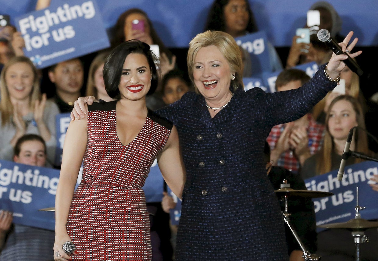 Democratic presidential candidate Hillary Clinton is joined by singer Demi Lovato at a campaign event in Iowa City, Iowa, Jan. 21, 2016. 