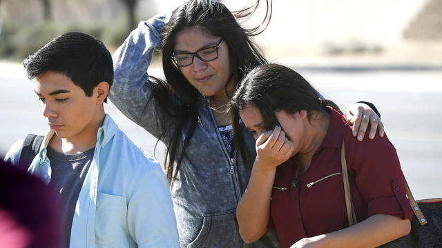 Students walk to their parents after being released from lockdown Feb. 12, 2016, in Glendale, Ariz., after two students were shot and killed at Independence High School in the Phoenix suburb. 