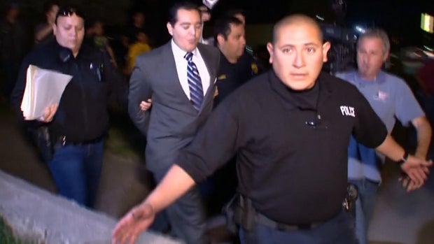 Mayor Ricardo Lopez of Crystal City, Texas, is led away from a city council meeting in handcuffs after an apparent scuffle Feb. 16, 2016. 