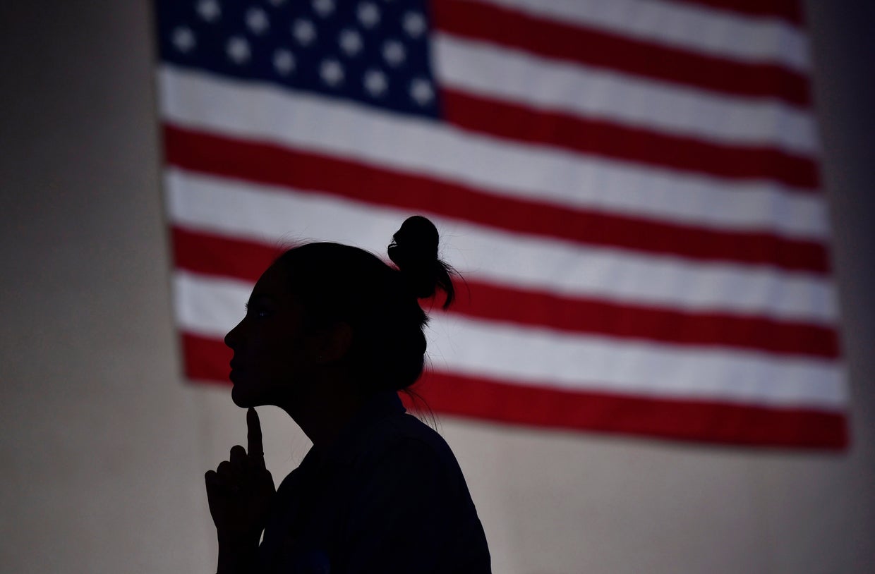 A supporter of Democratic presidential candidate Hillary Clinton watches election results at Clinton's victory rally before Clinton was projected as the winner in the Nevada Democratic caucus Feb. 20, 2016. 