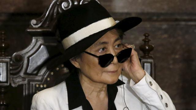 Artist Yoko Ono listens through an earpiece before she was honored as an "illustrious visitor" by Mexico City's Mayor Miguel Angel Mancera at Mexico City's town hall Feb. 3, 2016. 