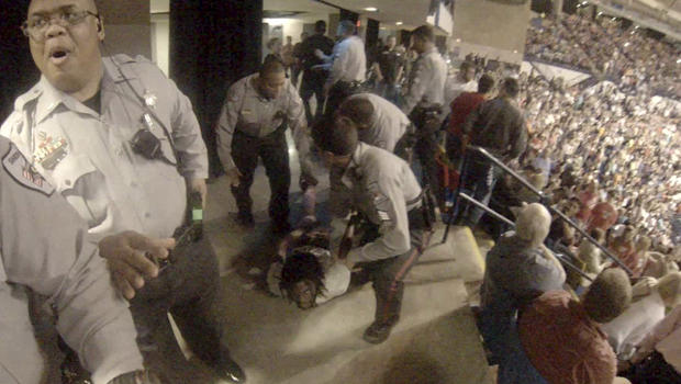 Rakeem Jones lies on the ground while being removed by deputies from a Donald Trump rally in Fayetteville, North Carolina, March 9, 2016, in a still image from video provided by Ronnie Rouse March 10, 2016. 