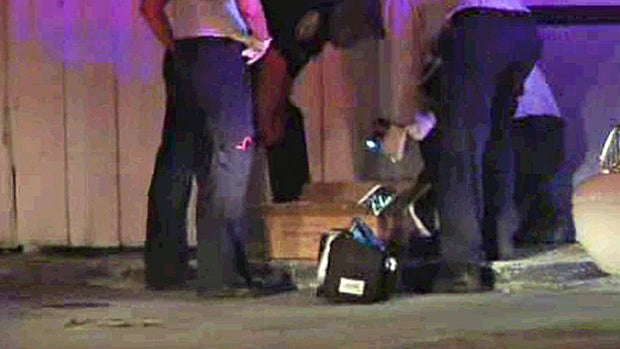 ​Police investigate a box where a baby's body was found in a dumpster in a North Miami, Florida, gas station on Sept. 5, 2014. 
