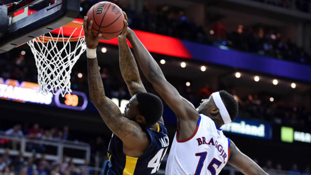 West Virginia Mountaineers forward Elijah Macon (45) shoots as Kansas Jayhawks forward Carlton Bragg Jr. (15) tries to block the shot in the championship game of the Big 12 Conference tournament at the Sprint Center in Kansas City, Missouri, on March 12,  