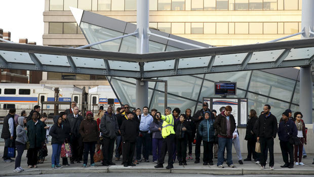 Morning commuters await a bus for downtown Washington in Silver Spring, Maryland, March 16, 2016. 