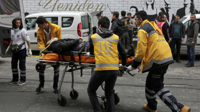 A man is helped by emergency services members following a suicide bombing in a major shopping and tourist district in central Istanbul March 19, 2016. 