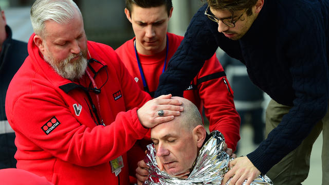 A victim receives first aid by rescuers on March 22, 2016, near the Maalbeek metro station in Brussels, Belgium, after an explosion near European Union institutions caused deaths and injuries. 