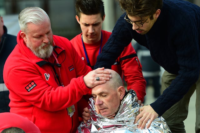A victim receives first aid by rescuers on March 22, 2016, near the Maalbeek metro station in Brussels, Belgium, after an explosion near European Union institutions caused deaths and injuries.