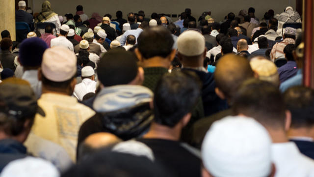 Men queue to enter the main prayer hall of the East London Mosque for the first Friday prayers of the Islamic holy month of Ramadan on June 19, 2015, in London, England. 