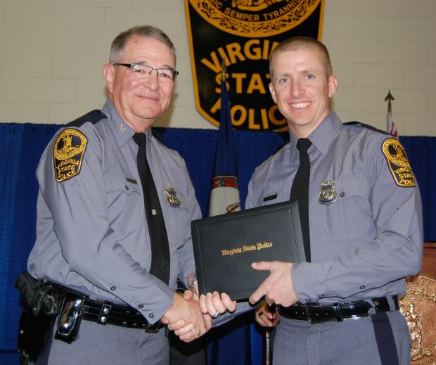 Trooper Dermyer at his VSP Academy graduation being presented his diploma by Col. W. Steven Flaherty, Virginia State Police Superintendent. 