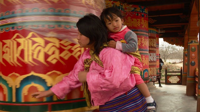 bhutanese-mother-and-child-at-prayer-wheel-promo.jpg 