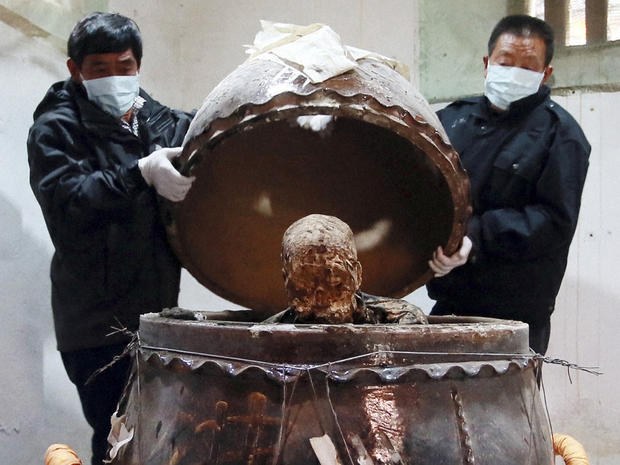The mummified body of revered Buddhist monk Fu Hou, who died in 2012 at the age of 94, is revealed inside a large pottery jar in Quanzhou 