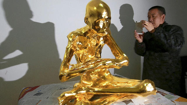 ​The gold leaf-covered, mummified body of revered Buddhist monk Fu Hou, who died in 2012 at the age of 94, is seen in Quanzhou, in southeastern China 