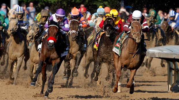 Mario Gutierrez aboard Nyquist (purple) races Florent Geroux aboard Gun Runner (right) during the 142nd running of the Kentucky Derby at Churchill Downs May 7, 2016. 
