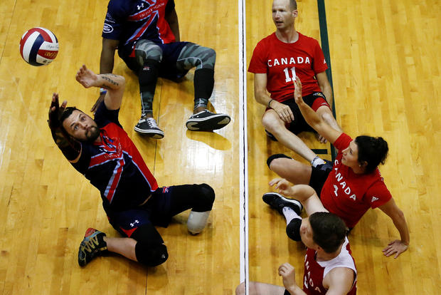 A competitor from the U.K. hits the ball to Canada during a seated wheelchair game at the Invictus Games in Orlando, Florida, May 7, 2016.​ 