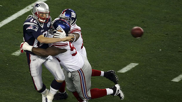 Tom Brady throws as he is hit - Super Bowl XLII 