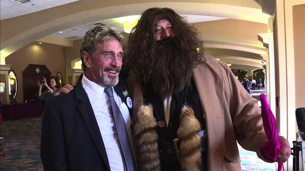 Libertarian candidate John McAfee poses with a man dressed as Hagrid at the Libertarian National Convention in Orlando, Florida, on May 27, 2016. 
