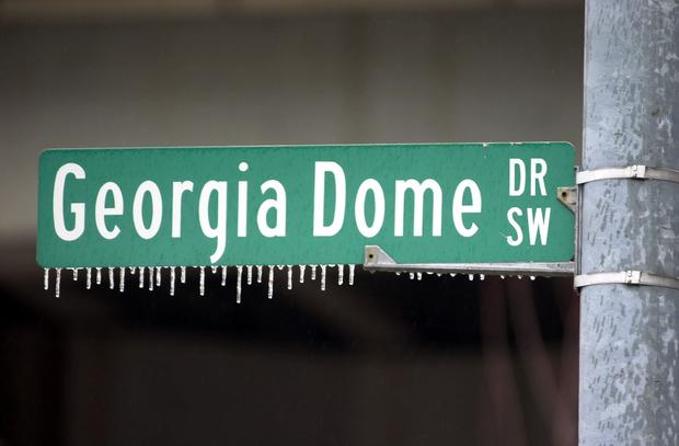 Icicles clings from a street sign in front of the 