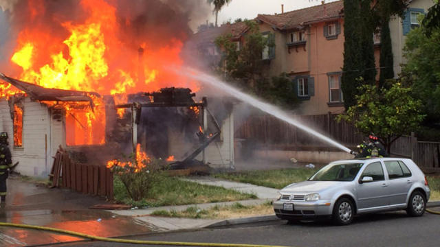 ​Firefighters battle a blaze at a home where a suspected gunman barricaded himself in Fremont, California, on June 2, 2016. 