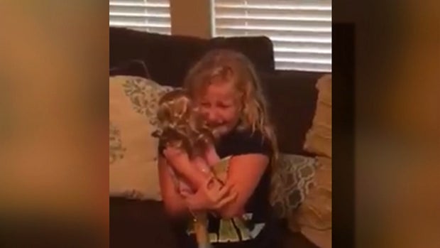 ​Emma Bennett, 10, hugs an American Girl doll that was modified to have a prosthetic leg just like her in this picture provided to CBS Houston affiliate KHOU-TV. 