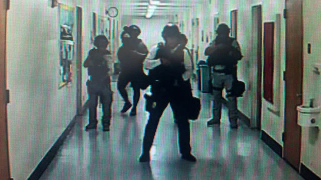 ​Police officers search corridors and rooms after a report of an active shooter on the UCLA campus in Los Angeles, California, June 1, 2016, in a still image from a CCTV camera. 