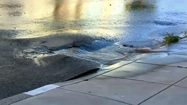 Buckled Street in S.F. Visitacion Valley after Water Main Ruptures 