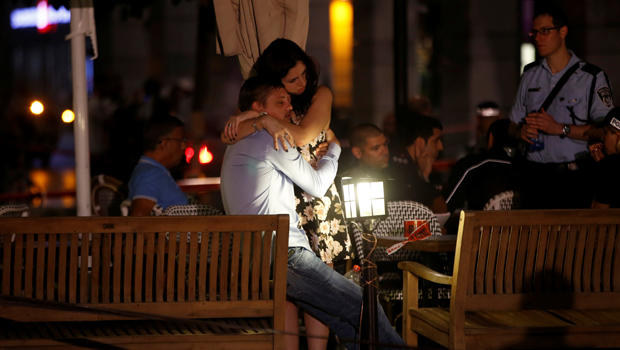 People hug each other following a shooting attack that took place in the center of Tel Aviv on June 8, 2016.​ 
