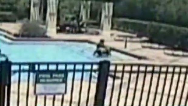 ​A toddler is carried out of a community pool in Titusville, Florida, after nearly drowning on June 3, 2016, in this image capture from surveillance video provided to CBS Orlando affiliate WKMG-TV. 
