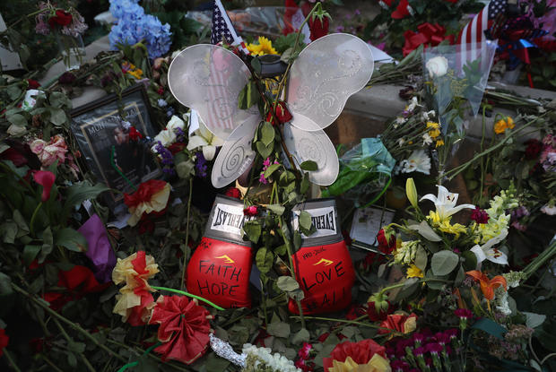 Mementos, including a pair of boxing gloves, lie at a makeshift memorial for Muhammad Ali outside the Muhammad Ali Center on June 8, 2016, in Louisville, Kentucky. 