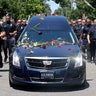 Louisville Metro Police surround Muhammad Ali's hearse as it drives past his boyhood home in Louisville, Kentucky, June 10, 2016.​ 