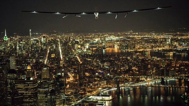 ​Solar Impulse 2, the solar airplane piloted by Swiss adventurer Andre Borschberg, flies over Manhattan on June 11, 2016, shortly before landing at John F. Kennedy airport. 