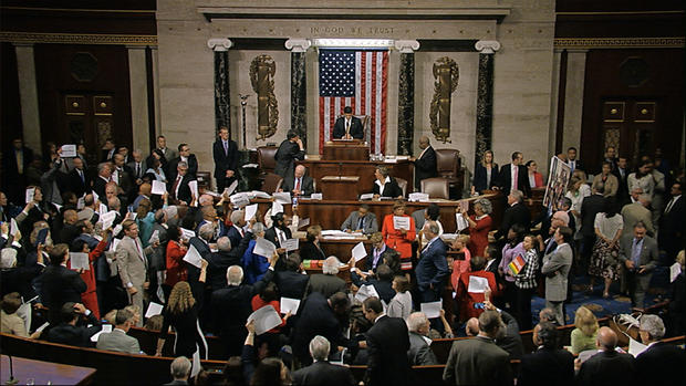 Image from video provided by House Television shows House Speaker Paul Ryan at podium attempting to bring House back in order late on night of June 22, 2016 as Democrats stand up from sit-in to hold up signs with names of mass shooting victims 