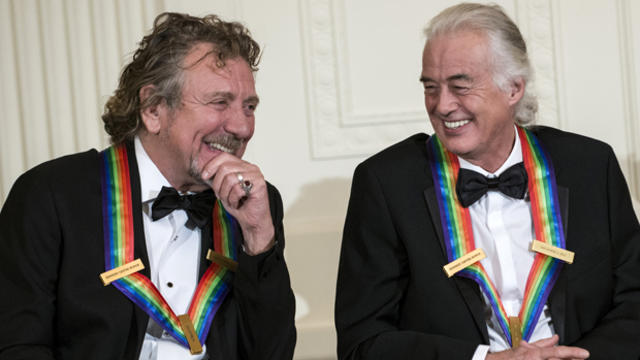 Led Zeppelin band members Robert Plant, left, and Jimmy Page listen during an event in the East Room of the White House Dec. 2, 2012, in Washington. 