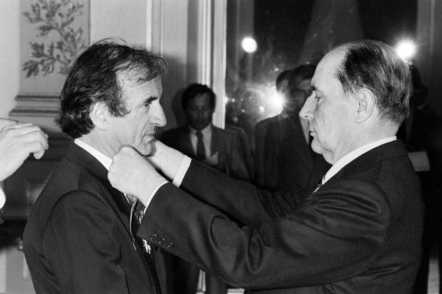 French President Francois Mitterrand, right, awards American writer Elie Wiesel with the Legion of Honor on May 9, 1984, at the Elysee Palace in Paris. 