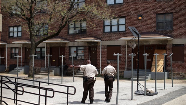 Deputies from the Baltimore City Sheriff's Office walk through the Gilmor Homes delivering eviction notices April 19, 2016, in Baltimore, Maryland. 