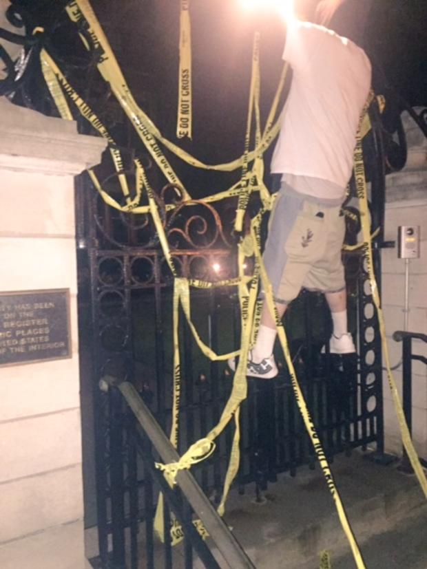 protester-hangs-from-fence-at-governors-mansion.jpg 