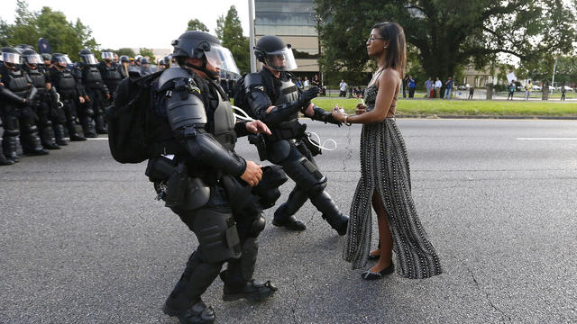 A demonstrator protesting the shooting death of Alton Sterling is detained by law enforcement near the headquarters of the Baton Rouge Police Department in Baton Rouge, Louisiana, July 9, 2016. 