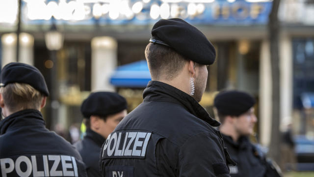 Police stand in front of the Bayerischer Hof hotel, the location for the 52nd Munich Security Conference, in Munich, Germany, on Feb. 11, 2016. 