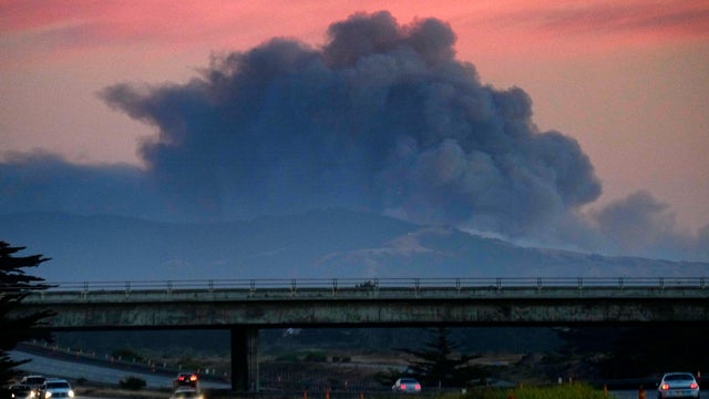 A large plume of smoke from a wildfire rises near Highway 1, burning five miles south of Carmel, Calif., on July 22, 2016. 