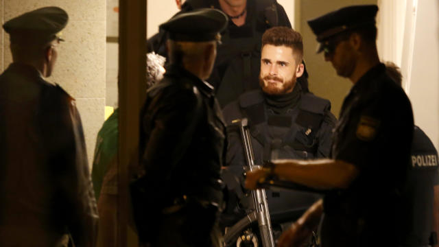 Police officers are pictured at the entrance of an apartment building following a shooting rampage at Olympia shopping mall in Munich, Germany, on July 23, 2016. 