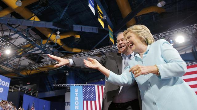 Democratic presidential candidate Hillary Clinton arrives on stage with U.S. Sen. Tim Kaine, D-Virginia, as her vice presidential running mate during a campaign rally in Miami, Florida, July 23, 2016. 