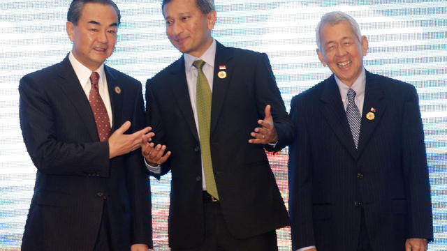 Chinese Foreign Minister Wang Yi, left, talks to Singapore's Foreign Minister Vivian Balakrishnan, center, and Philippine Foreign Secreatary Perfecto Yasay 