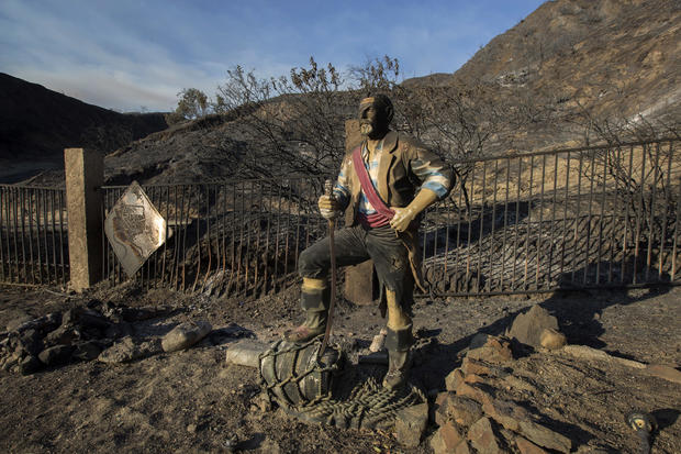 Burned pirate sculpture stands in a landscape scared by the Sand Fire on July 25, 2016, in Santa Clarita, California 
